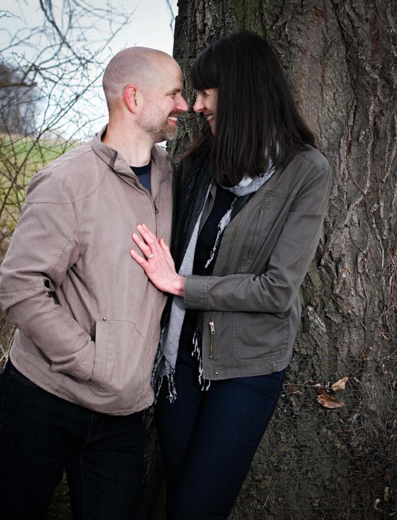 A couple by a tree.