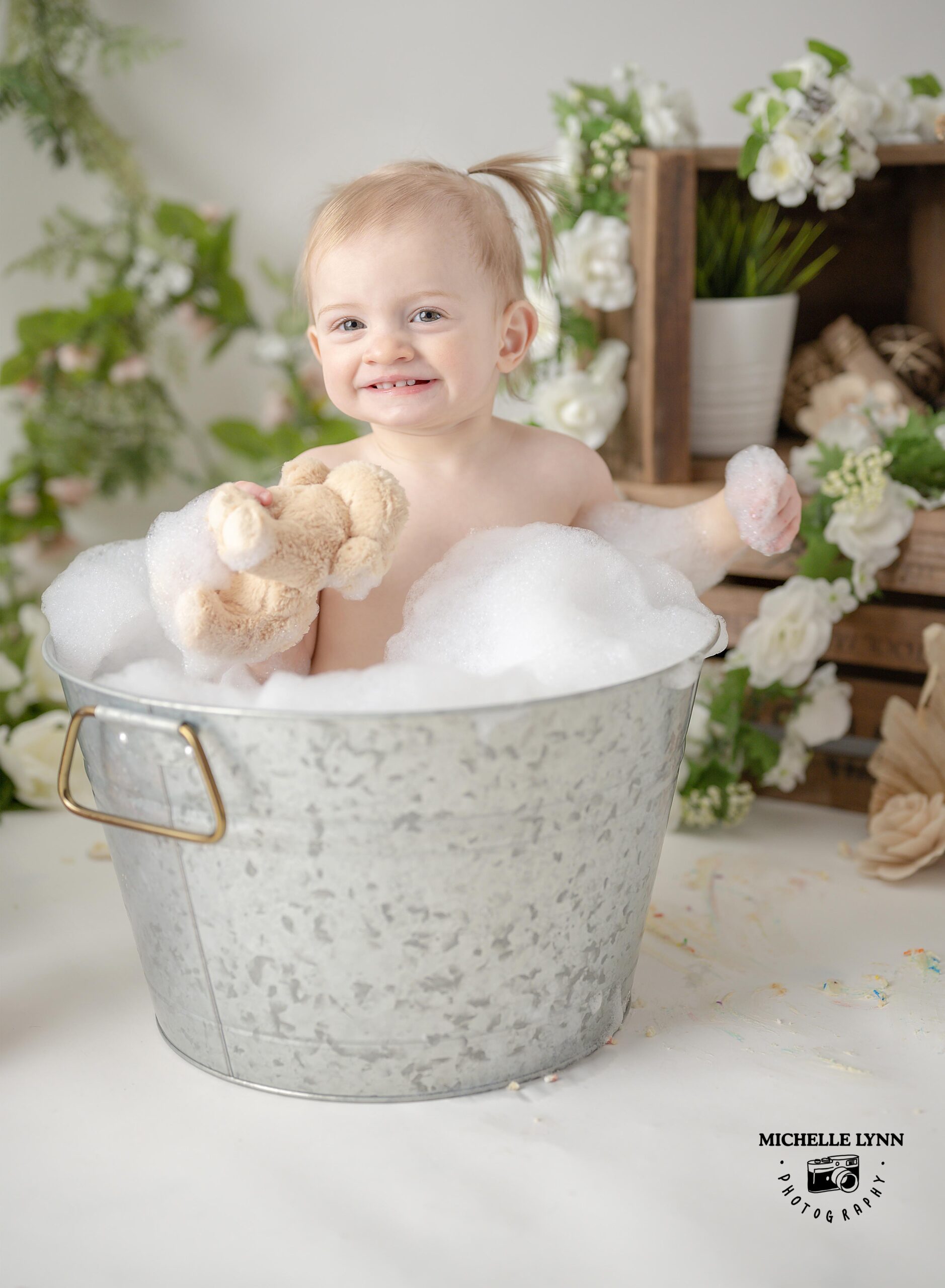 One year old Birthday girl in a bubble bath.